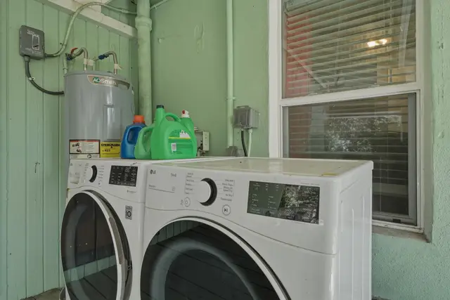 Convenient in-unit laundry with modern washer, dryer, and natural light at Fruit Tree Home