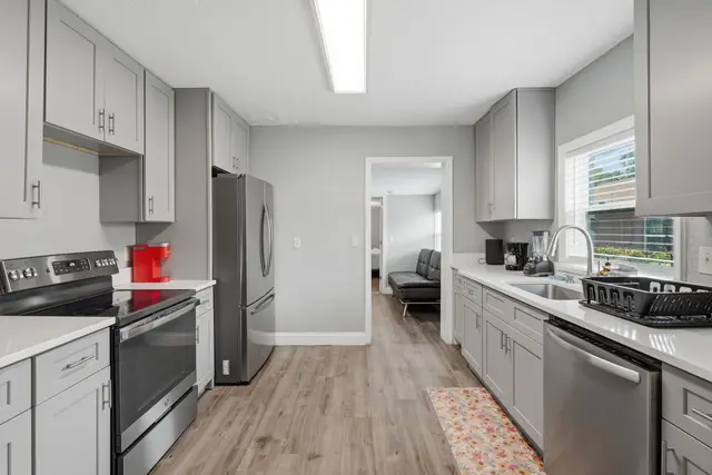 Bright modern kitchen with stainless appliances and spacious counters at Fruit Tree Home