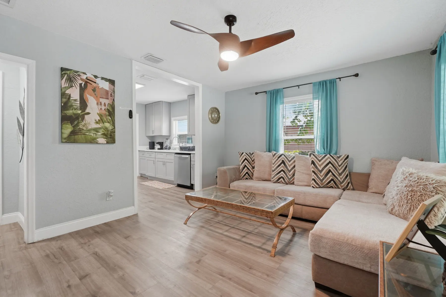Bright, stylish living room with cozy sectional and open kitchen view at Fruit Tree Home, a Libema home in Orlando
