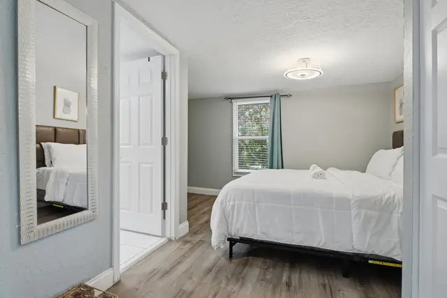 Bright, cozy bedroom with crisp linens and natural light at Fruit Tree Home