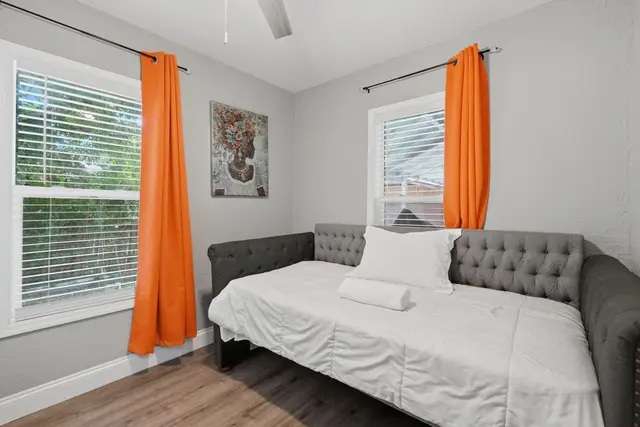 Bright, cozy daybed nook with natural light and bold, stylish accents at Fruit Tree Home