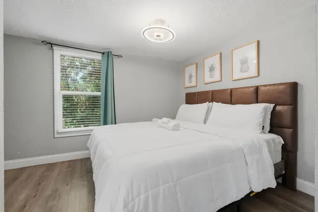 Bright, cozy bedroom with plush linens and peaceful natural light at Fruit Tree Home