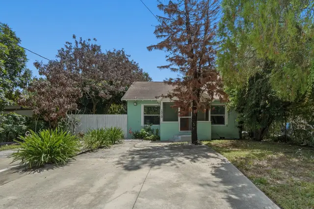 Charming mint-green cottage with private driveway and leafy yard at Fruit Tree Home