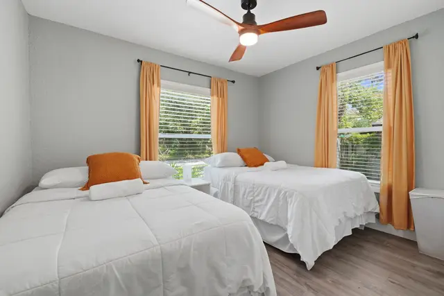 Bright twin-bed room with natural light and a clean, modern feel at Fruit Tree Home