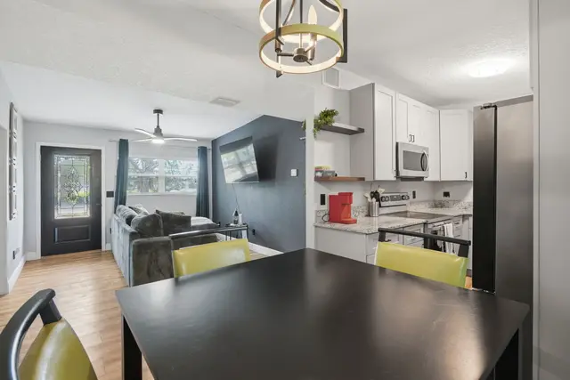 Bright open-concept living with modern kitchen, dining area, and cozy lounge at Amelia’s Arena Retreat