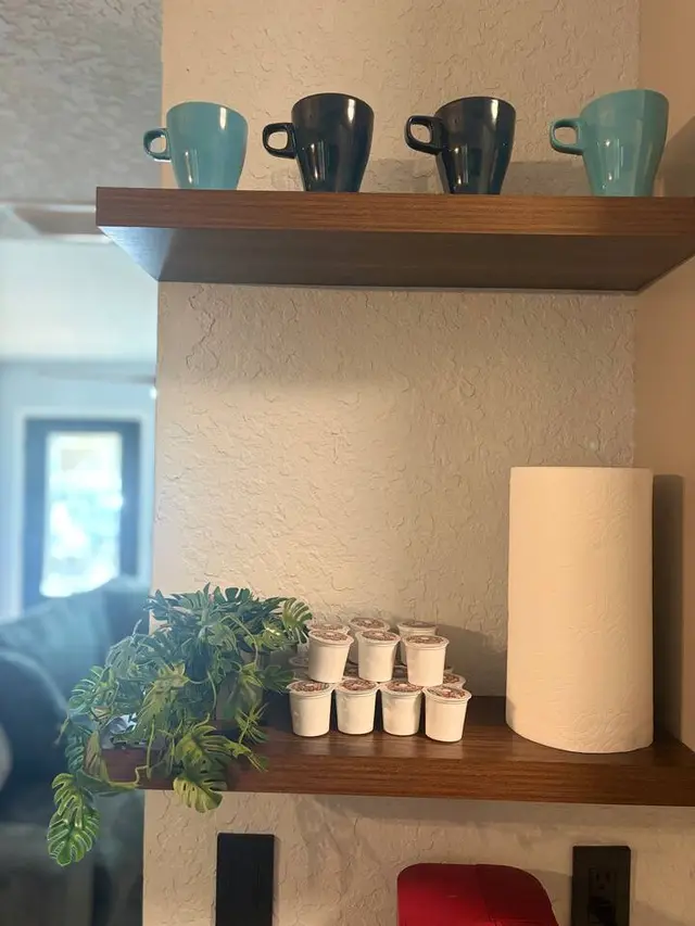 Cozy coffee station with mugs, pods, and stylish floating shelves at Amelia’s Arena Retreat