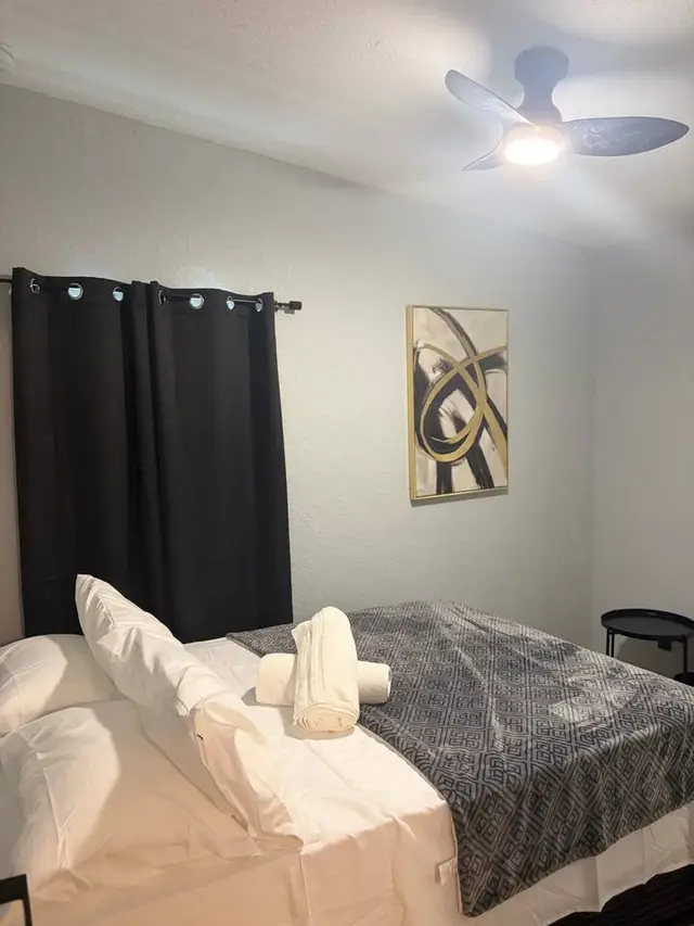 Cozy bedroom with blackout curtains, fresh linens, and modern touches at Amelia’s Arena Retreat