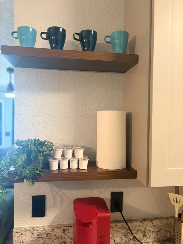 Cozy coffee station with stocked pods, mugs, and stylish open shelving at Amelia’s Arena Retreat