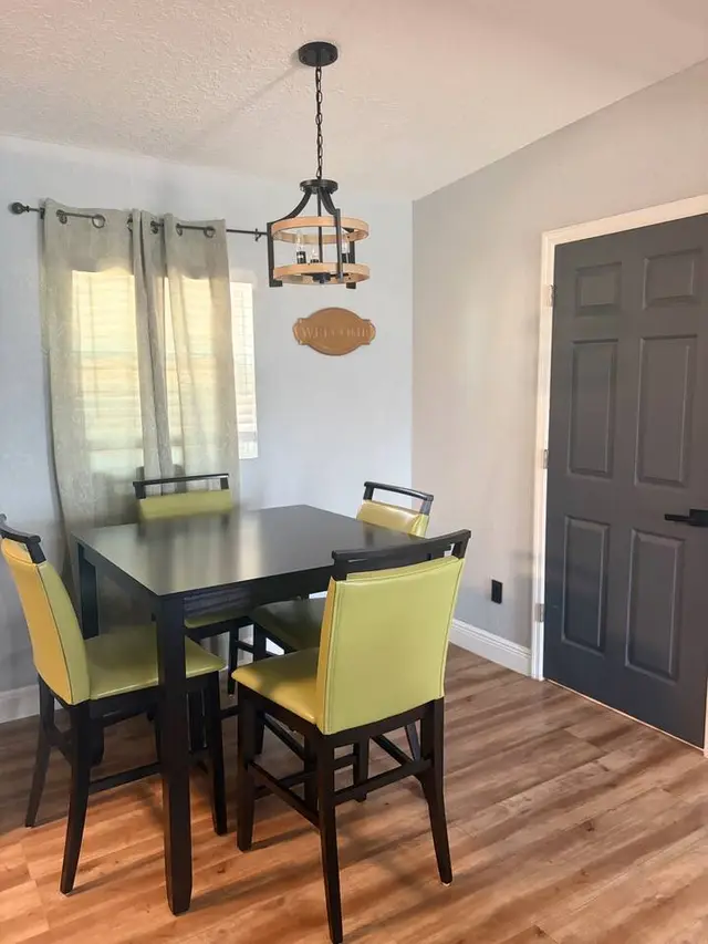 Cozy dining nook with modern lighting and seating for four at Amelia’s Arena Retreat