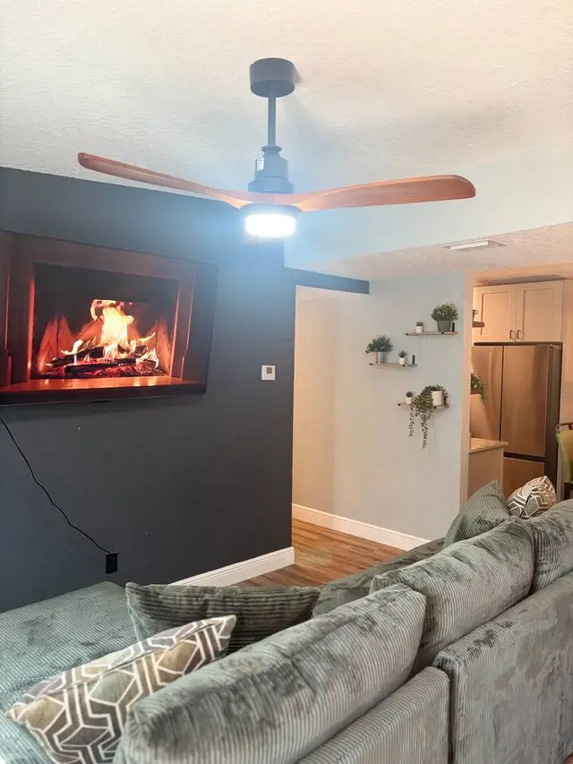 Cozy living room with fireplace ambiance and stylish open layout at Amelia’s Arena Retreat
