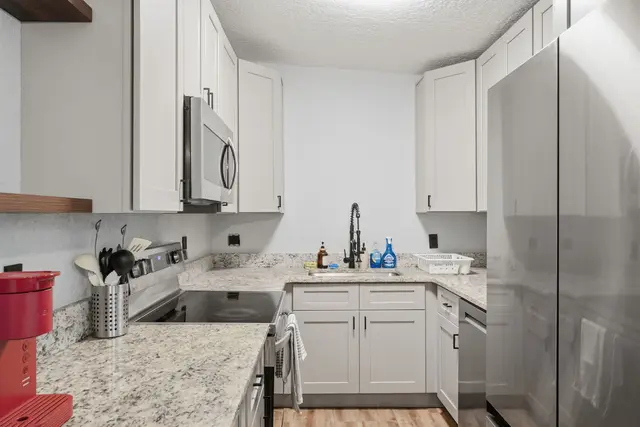 Bright modern kitchen with stainless appliances and generous counter space at Amelia’s Arena Retreat