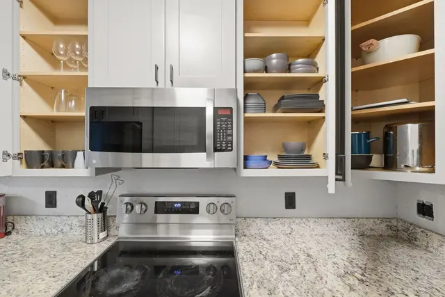 Well-stocked modern kitchen with stainless appliances and ample storage at Amelia’s Arena Retreat