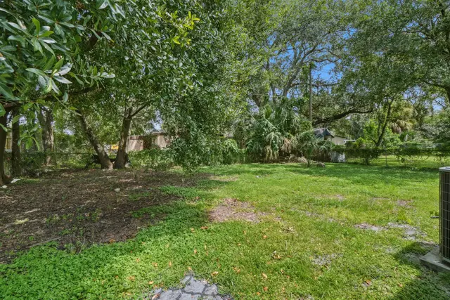 Spacious, tree-shaded backyard with lush greenery and room to unwind at Amelia’s Arena Retreat