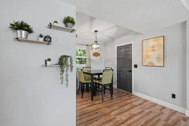 Bright, stylish dining nook with modern decor and seating for four at Amelia’s Arena Retreat