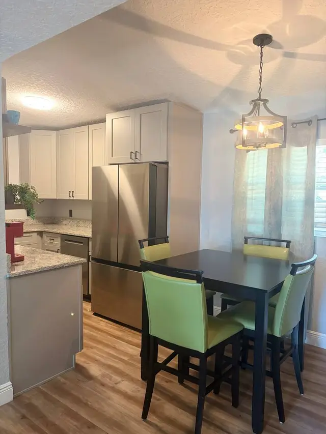 Bright modern kitchen with dining for four and stainless appliances at Amelia’s Arena Retreat