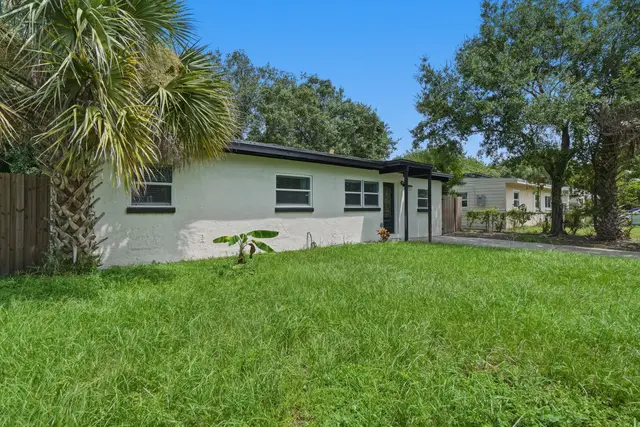 Charming home with spacious yard, tropical trees, and fresh curb appeal at Amelia’s Arena Retreat