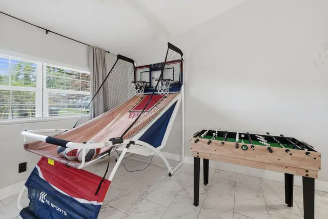 Bright game room with basketball arcade and foosball fun at Piedmont