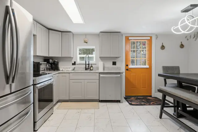 Bright modern kitchen with stainless appliances and cheerful dining nook at Piedmont