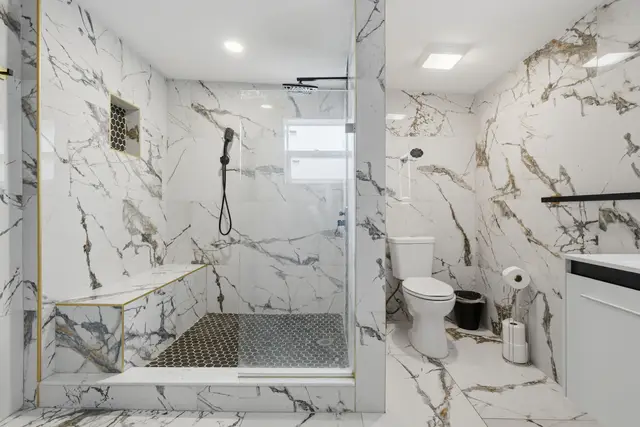 Luxurious marble-style bathroom with spacious walk-in glass shower at Piedmont