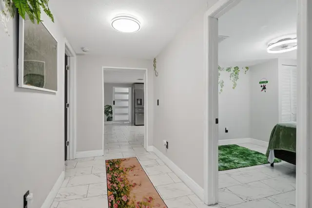 Bright modern hallway with sleek tile floors and stylish green accents at Piedmont