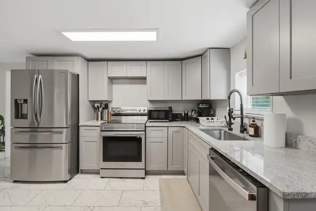 Bright modern kitchen with stainless appliances and ample counter space at Piedmont