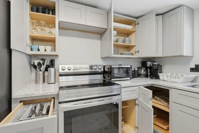 Bright, fully stocked kitchen with stainless appliances and ample storage at Piedmont