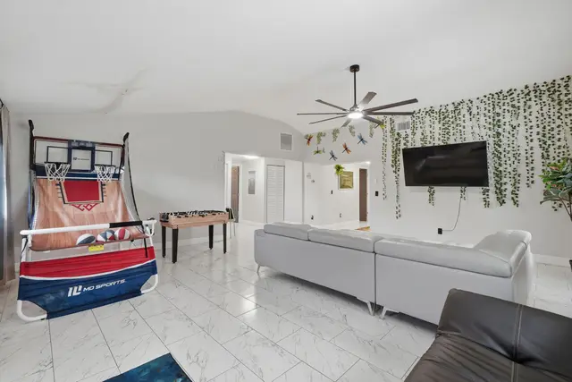 Spacious game room lounge with TV, foosball, and indoor basketball fun at Piedmont