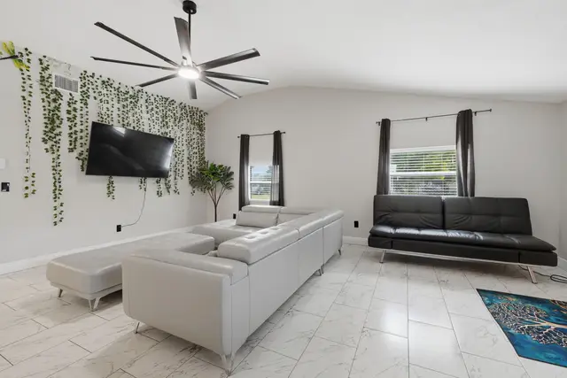 Bright modern living room with large sectional, TV, and stylish decor at Piedmont