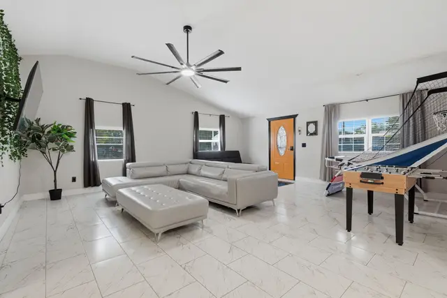 Bright open living room with modern seating, high ceilings & foosball fun at Piedmont