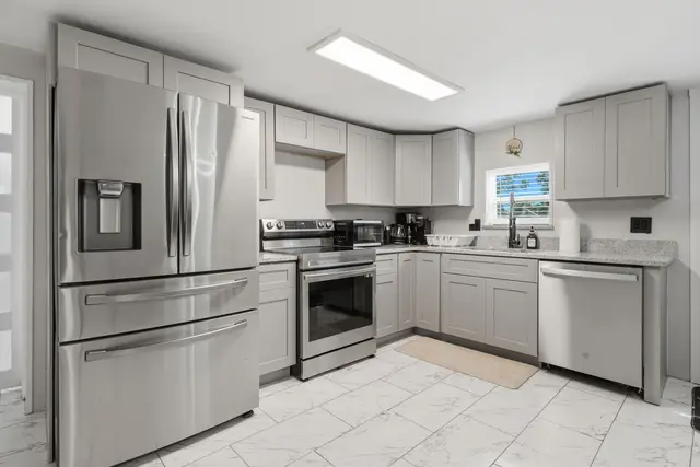 Bright modern kitchen with stainless appliances and ample counter space at Piedmont