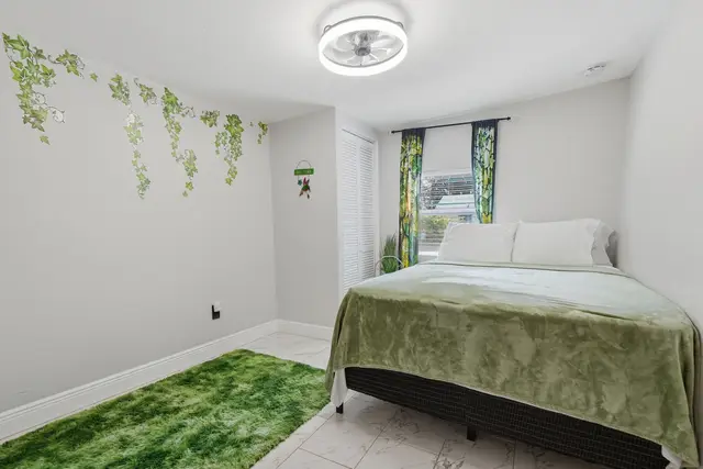 Cozy nature-inspired bedroom with bright light and soft green accents at Piedmont