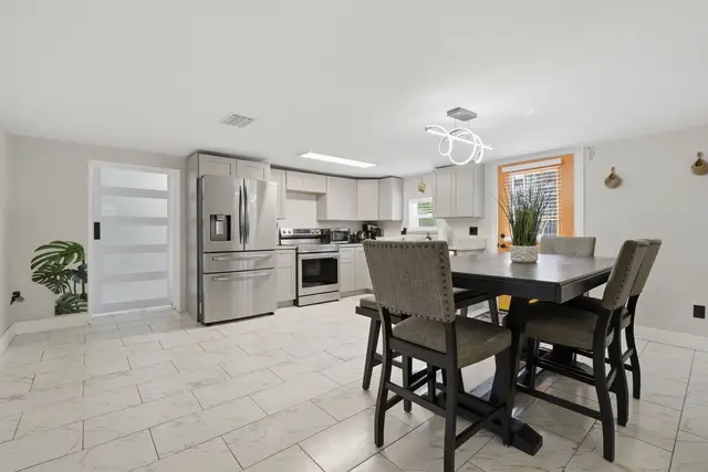 Bright modern kitchen and dining space with stainless steel appliances at Piedmont