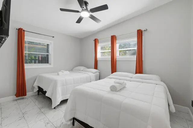 Bright double bedroom with TV, natural light, and modern finishes at Game Day Getaway-Downtown Orlando