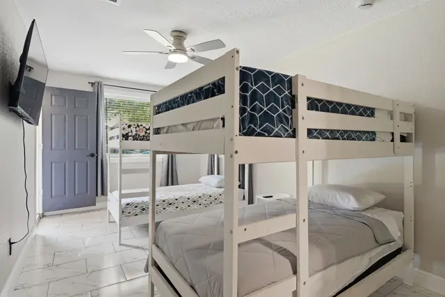 Bright bunk room with TV—perfect for families and group stays at Game Day Getaway-Downtown Orlando