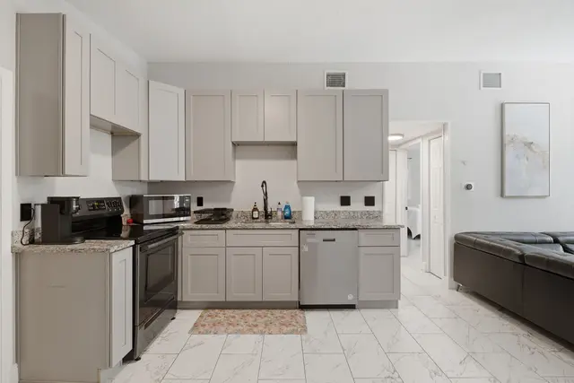 Bright modern kitchen with stylish finishes and open living access at Game Day Getaway-Downtown Orlando