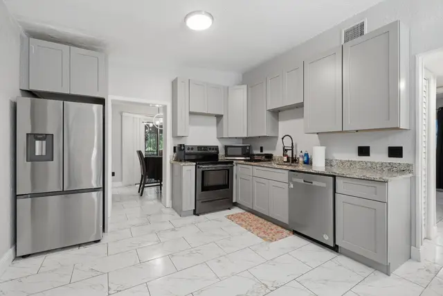Bright modern kitchen with stainless appliances and ample cabinet space at Game Day Getaway-Downtown Orlando