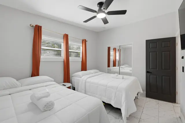 Bright double bedroom with two cozy beds and clean, modern touches at Game Day Getaway-Downtown Orlando