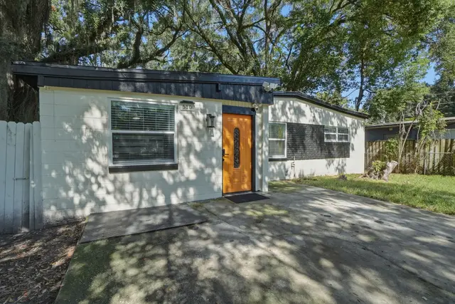 Modern single-story home with private driveway and shaded curb appeal at Game Day Getaway-Downtown Orlando