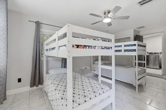 Bright bunk room with modern beds, airy design, and group-friendly comfort at Game Day Getaway-Downtown Orlando