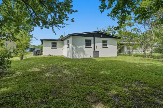 Spacious backyard with shady trees and plenty of room to relax outdoors at WinterPark Home