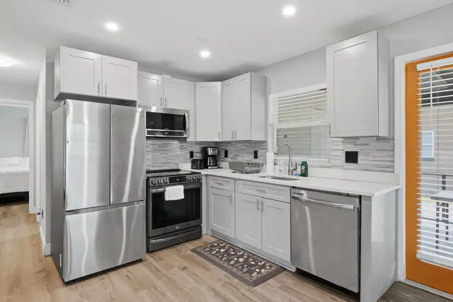 Bright modern kitchen with stainless appliances and stylish finishes at WinterPark Home