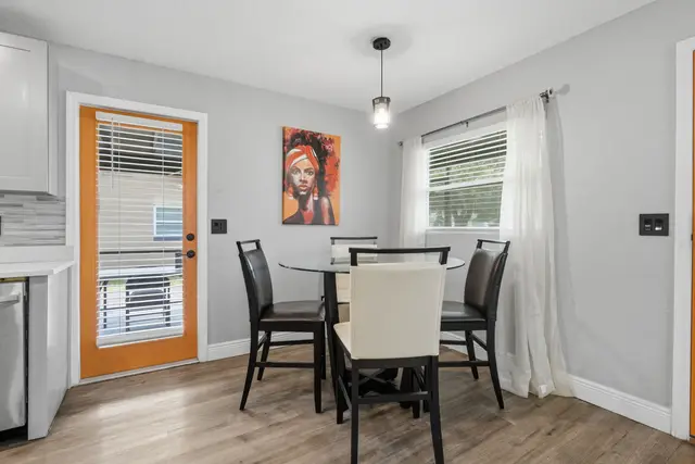 Bright modern dining nook with seating for four and stylish pops of color at WinterPark Home