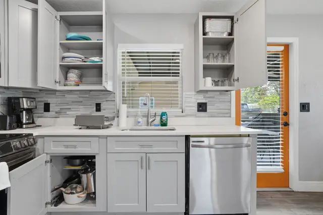 Bright modern kitchen with stainless appliances and sunny outdoor access at WinterPark Home