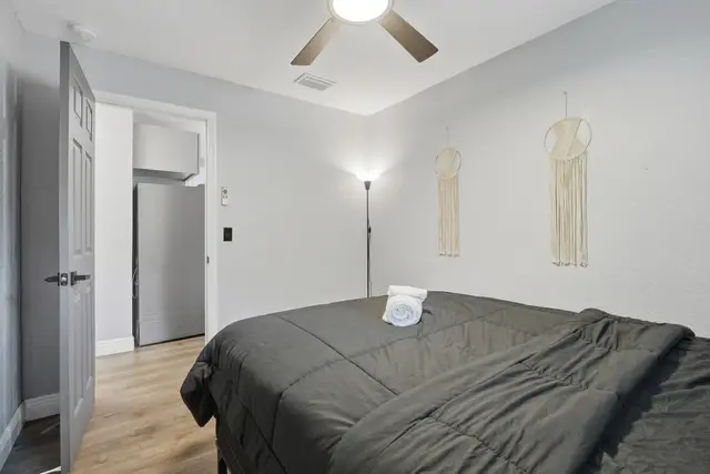 Cozy minimalist bedroom with mini fridge and modern touches at WinterPark Home