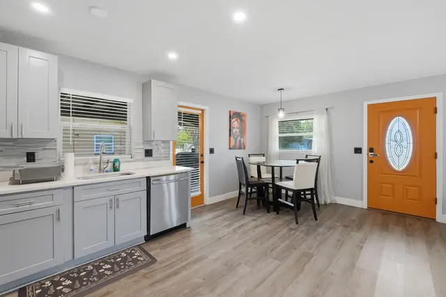 Bright modern kitchen and dining area with stylish pops of color at WinterPark Home