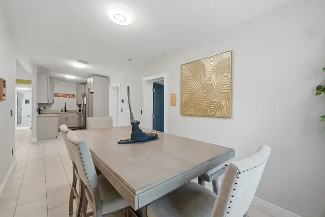 Spacious dining area with stylish seating and open-concept kitchen at The Clue House