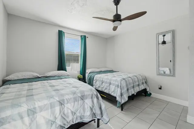 Bright double-bedroom with two comfy beds and a fresh, airy feel at The Clue House