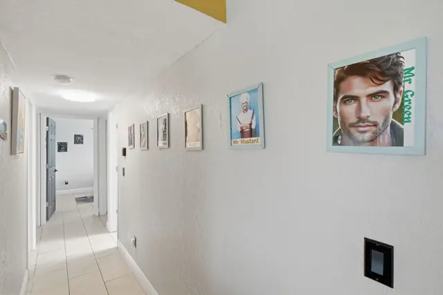 Bright tiled hallway with playful art and a clean, modern feel at The Clue House
