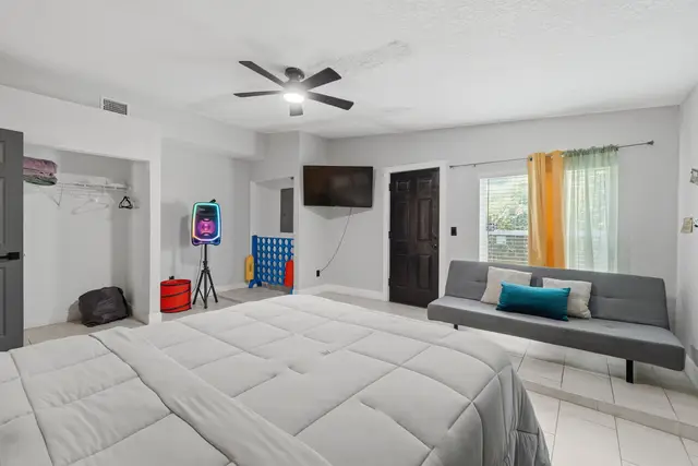 Spacious bedroom with futon, TV, and fun game-ready touches at The Clue House