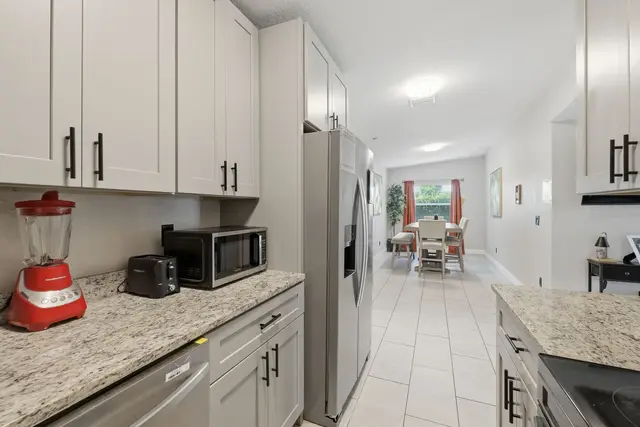 Bright modern kitchen with granite counters and open dining area at The Clue House